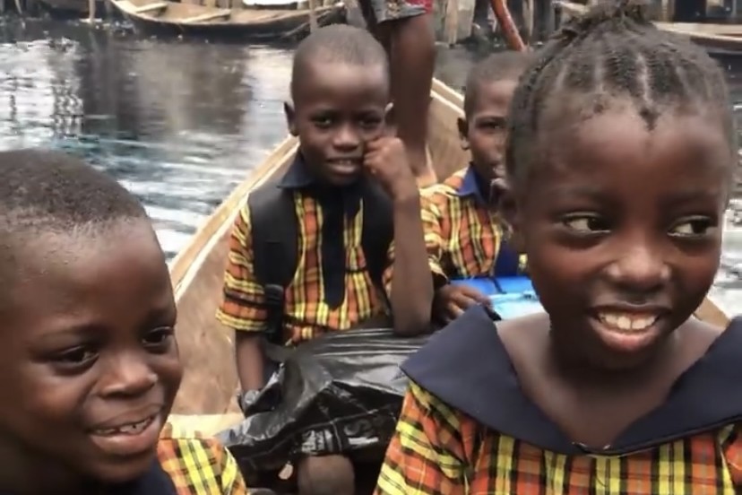 Schoolchildren in uniform in a canoe in Makoko, the floating community in Lagos